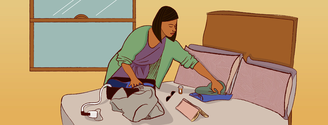 Woman packing a bag on a bed