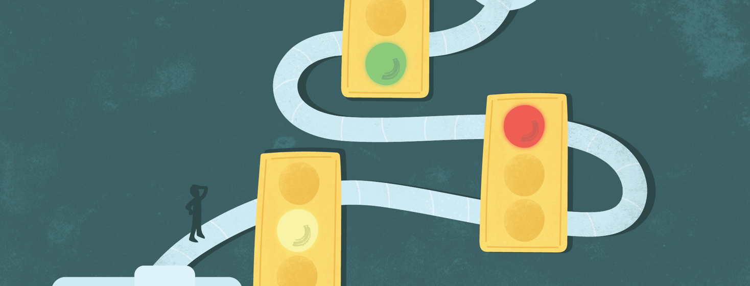 a person stands on a path made of CPAP tubing with three stoplights showing yellow, red, and green lights