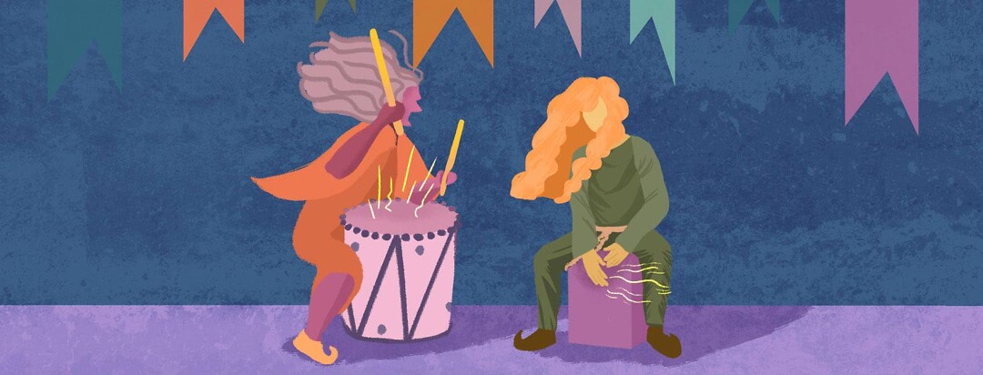 A person yelling and banging loudly on a drum, next to a wild-haired person also banging on a box used as a stool.
